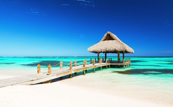 Beautiful gazebo on the tropical white sandy beach in Punta Cana, Dominican Republic (Photo via  Preto_perola / iStock / Getty Images Plus)