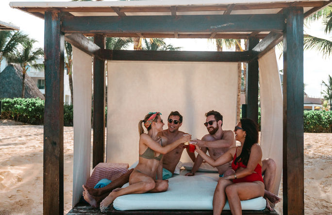 Friends enjoying a Bali Bed at Hard Rock Hotel & Casino Punta Cana
