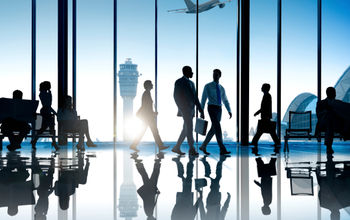 Corporate or business travelers walking through the airport.