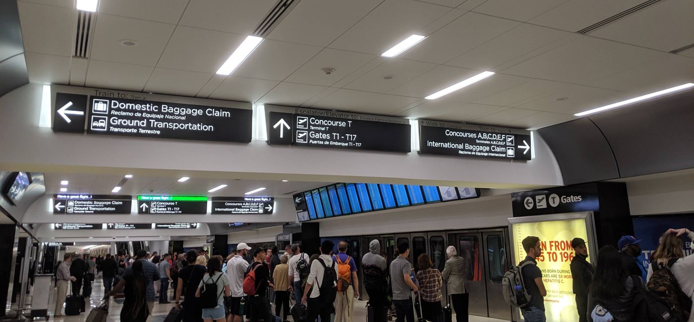 Image: A crowd of people waiting to board a tram at the Atlanta airport (photo by Eric Bowman)