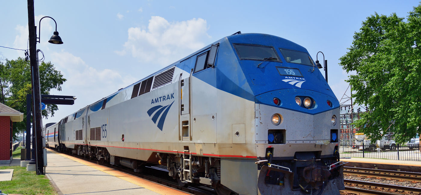Image: Amtrak train parked at a station. (Photo Credit: Adobe Stock/Bruce Leighty)