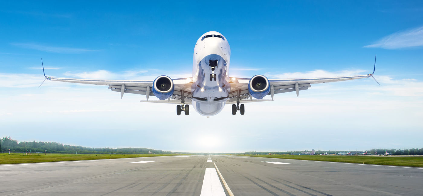 Image: Passenger airplane landing on a runway. (Photo Credit: Adobe Stock/aapsky)