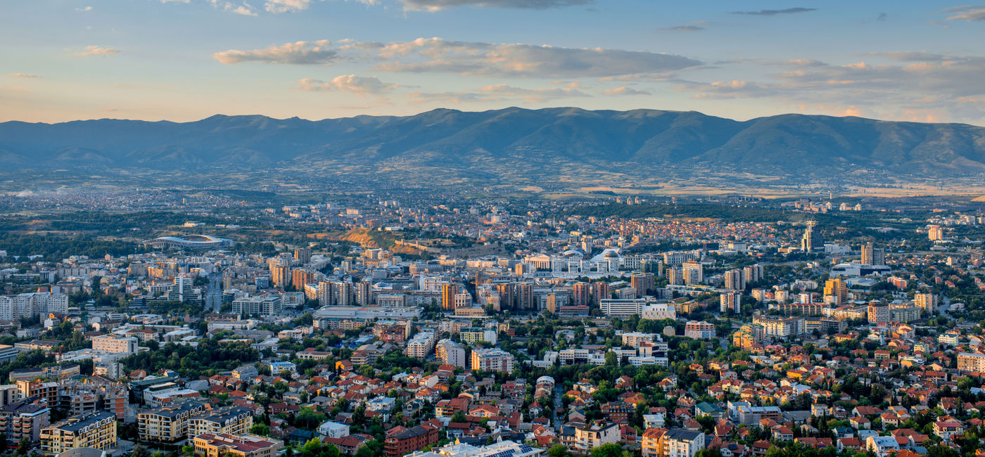 Image: Top view from Vodno mountain on Skopje city in Macedonia on sunset (photo via RossHelen / iStock / Getty Images Plus)