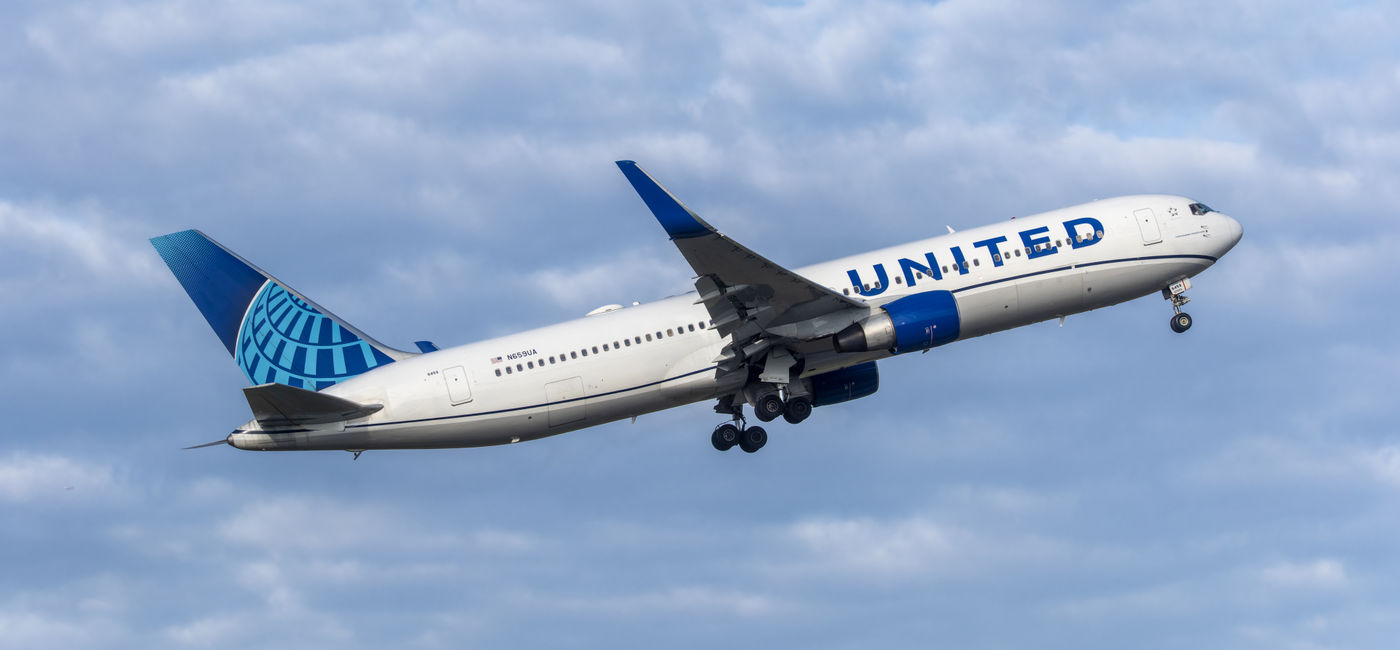 Image: United Airlines airplane in flight. (Photo Credit: Adobe Stock/hectorchristiaen)