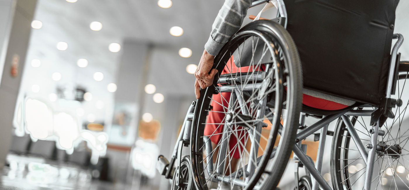 Image: Wheelchair user at the airport. (Photo Credit: Adobe Stock/Yakobchuk Olena)