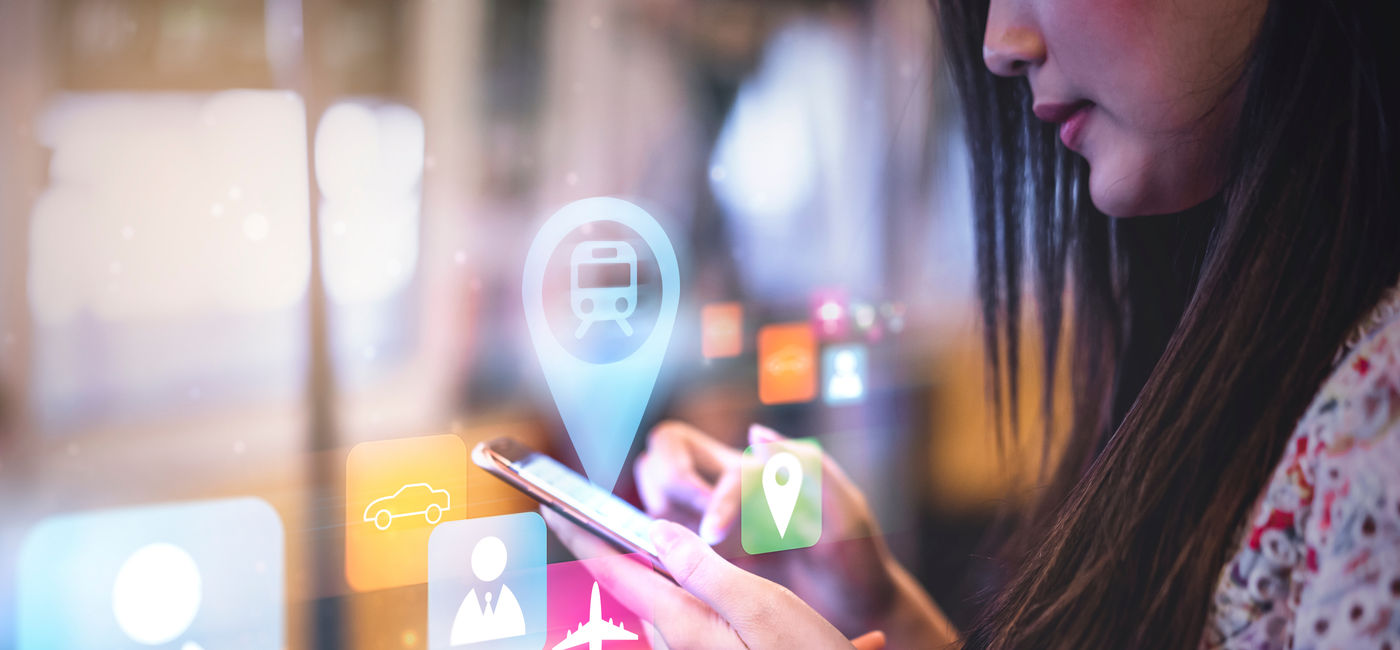 Image: Woman uses smart phone to check travel plans (Photo Credit: Have a nice day, Adobe Stock)
