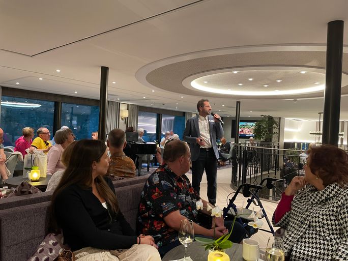 The Riviera Travel cruise director offers daily briefings in the lounge on Riviera Radiance The Riviera Travel cruise director offers daily briefings in the lounge on Riviera Radiance