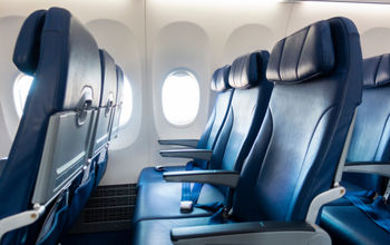 Rows of economy class airplane seating.