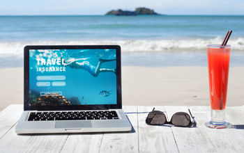 Shopping for travel insurance on a tropical beach.